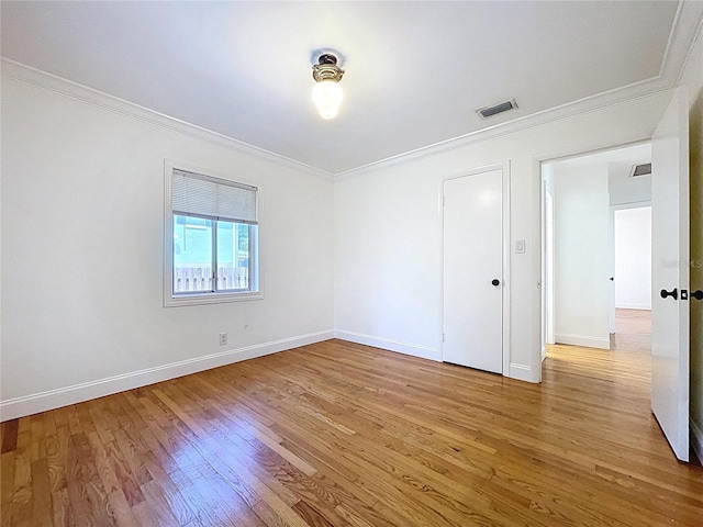 6920 Bougainvilla Ave S, Saint Petersburg, FL 33707 - empty room with ornamental molding, baseboards, light wood finished floors, and visible vents