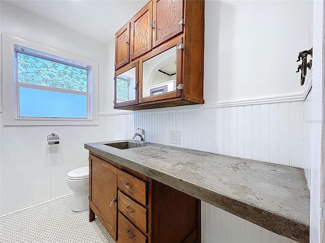 6920 Bougainvilla Ave S, Saint Petersburg, FL 33707 - bathroom with toilet, vanity, and a wainscoted wall