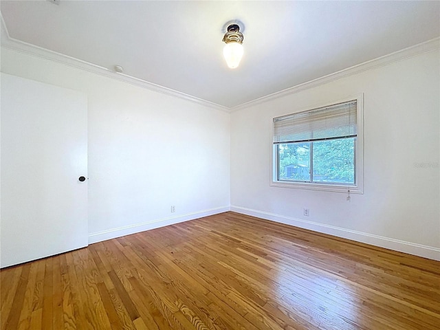 6920 Bougainvilla Ave S, Saint Petersburg, FL 33707 - empty room with ornamental molding, baseboards, and wood finished floors