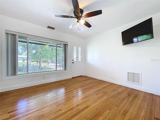 6920 Bougainvilla Ave S, Saint Petersburg, FL 33707 - unfurnished living room with light wood-style flooring, ceiling fan, baseboards, and visible vents
