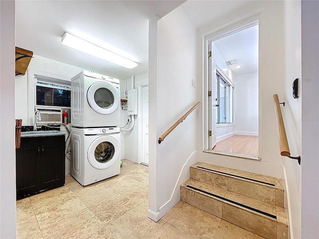 6920 Bougainvilla Ave S, Saint Petersburg, FL 33707 - laundry area featuring stacked washer and dryer, visible vents, laundry area, and a sink