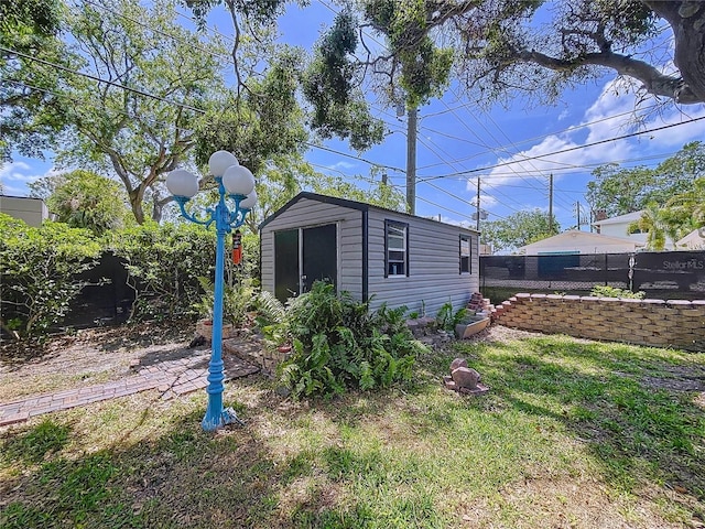 6920 Bougainvilla Ave S, Saint Petersburg, FL 33707 - view of yard featuring a fenced backyard and an outdoor structure