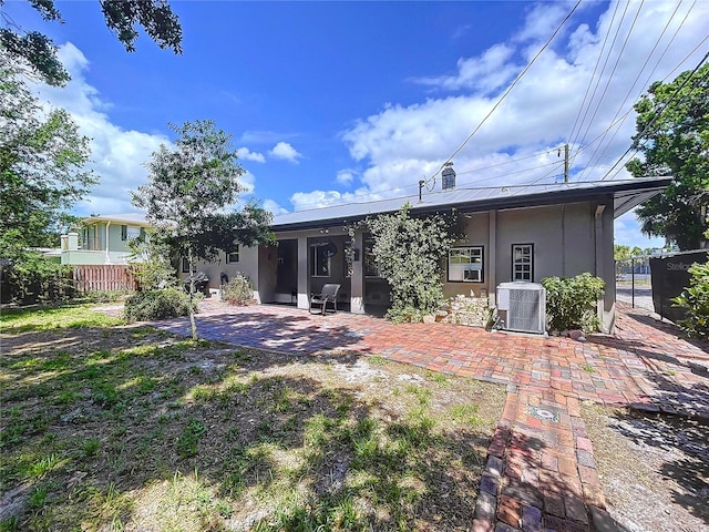 6920 Bougainvilla Ave S, Saint Petersburg, FL 33707 - back of property with cooling unit, a patio, stucco siding, and fence