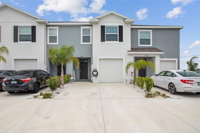 33083 Frosted Clover Way, Wesley Chapel, FL 33545 - view of front of property featuring stucco siding, a garage, and driveway