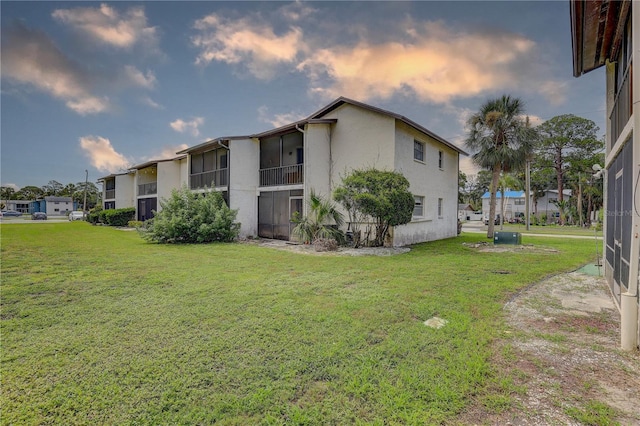 8440 Old Post Rd Unit 104, Port Richey, FL 34668 - view of side of home featuring a yard and stucco siding