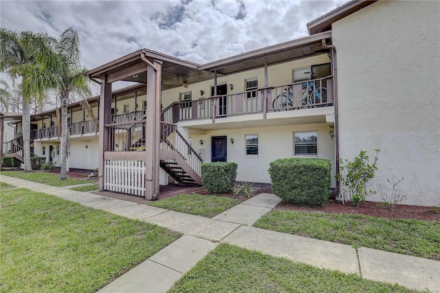 8440 Old Post Rd Unit 104, Port Richey, FL 34668 - view of building exterior featuring stairway
