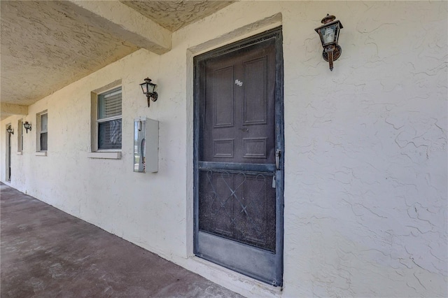 8440 Old Post Rd Unit 104, Port Richey, FL 34668 - property entrance with stucco siding and a porch