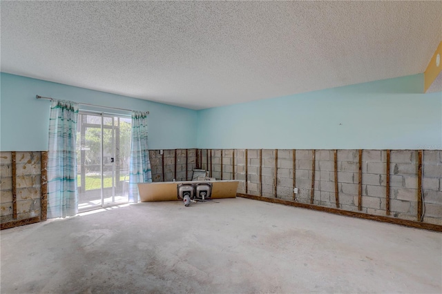 8440 Old Post Rd Unit 104, Port Richey, FL 34668 - spare room featuring concrete floors and a textured ceiling