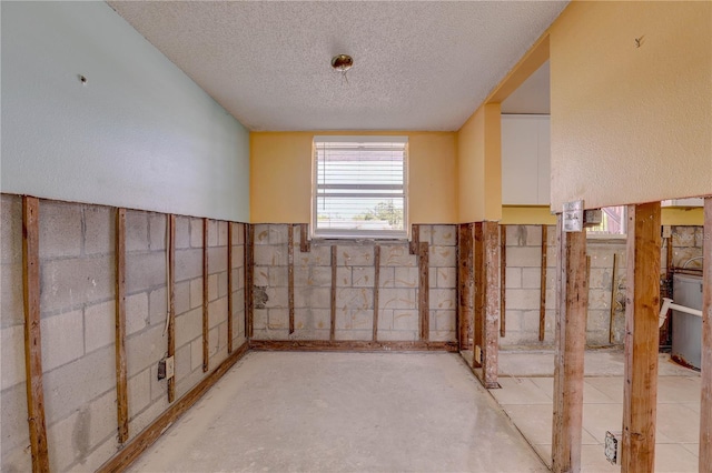 8440 Old Post Rd Unit 104, Port Richey, FL 34668 - below grade area with a textured ceiling and wainscoting