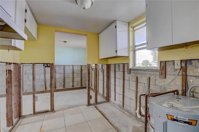 8440 Old Post Rd Unit 104, Port Richey, FL 34668 - basement with water heater and light tile patterned floors