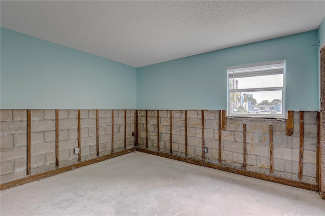 8440 Old Post Rd Unit 104, Port Richey, FL 34668 - empty room with concrete flooring and a textured ceiling