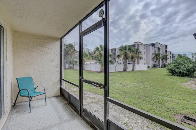 8440 Old Post Rd Unit 104, Port Richey, FL 34668 - unfurnished sunroom featuring a residential view