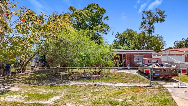 view of front of home with fence and a gate