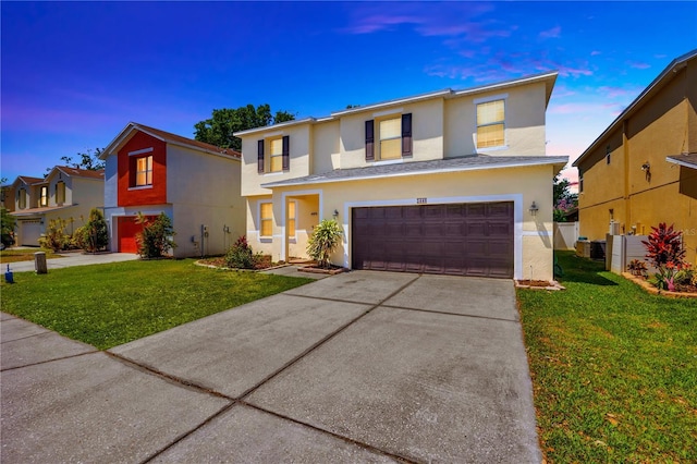 traditional-style house with stucco siding, a garage, and concrete driveway