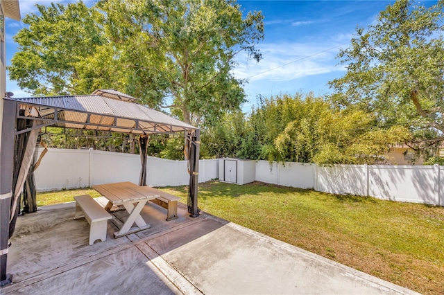 view of yard featuring a fenced backyard, a gazebo, and a patio