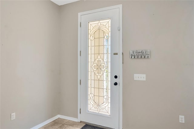 entryway with light tile patterned floors and baseboards