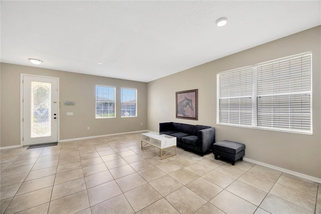 interior space featuring light tile patterned floors and baseboards