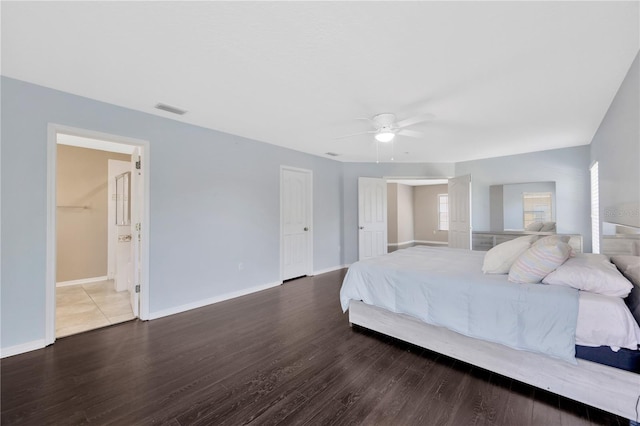 bedroom with wood finished floors, baseboards, a ceiling fan, and visible vents