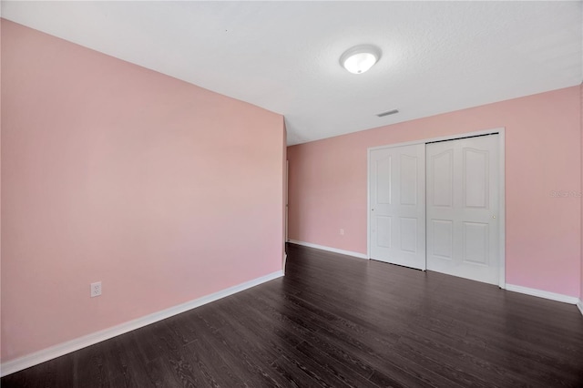 interior space featuring dark wood-style flooring, baseboards, and visible vents