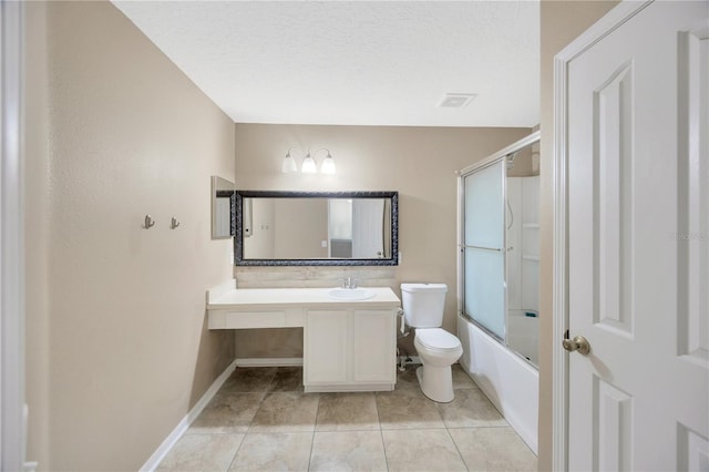 bathroom featuring vanity, tile patterned flooring, toilet, bath / shower combo with glass door, and baseboards