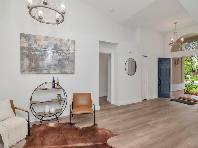 3728 Cypress Meadows Rd, Tampa, FL 33624 - sitting room featuring a chandelier, wood finished floors, baseboards, and a high ceiling