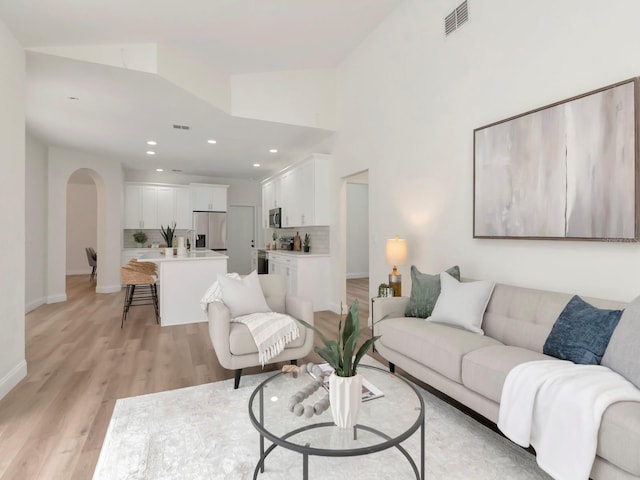 3728 Cypress Meadows Rd, Tampa, FL 33624 - living area with arched walkways, light wood-style flooring, recessed lighting, and baseboards
