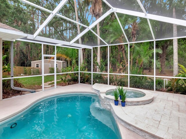 3728 Cypress Meadows Rd, Tampa, FL 33624 - view of swimming pool featuring glass enclosure, a patio, and a pool with connected hot tub