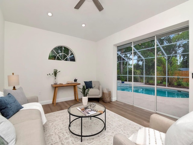 3728 Cypress Meadows Rd, Tampa, FL 33624 - living area featuring wood finished floors, a sunroom, a ceiling fan, baseboards, and recessed lighting