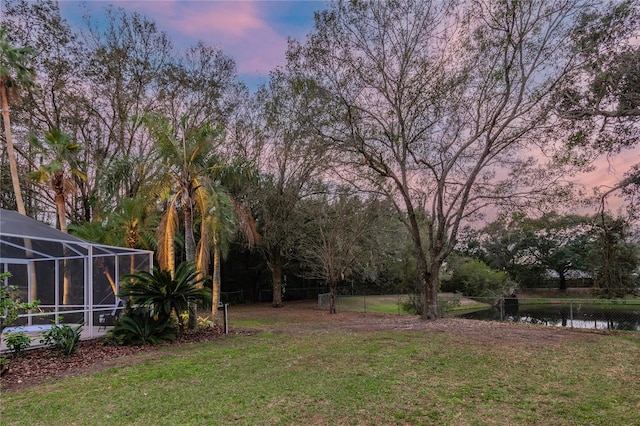 3728 Cypress Meadows Rd, Tampa, FL 33624 - yard at dusk featuring a lanai and a water view