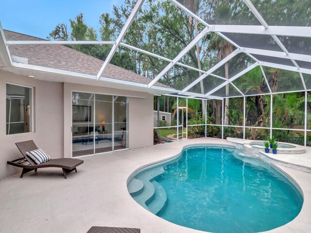 3728 Cypress Meadows Rd, Tampa, FL 33624 - view of swimming pool with a patio area, a pool with connected hot tub, and glass enclosure