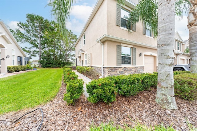 3844 Silverlake Way, Wesley Chapel, FL 33544 - view of home's exterior with stucco siding, stone siding, a lawn, and a garage