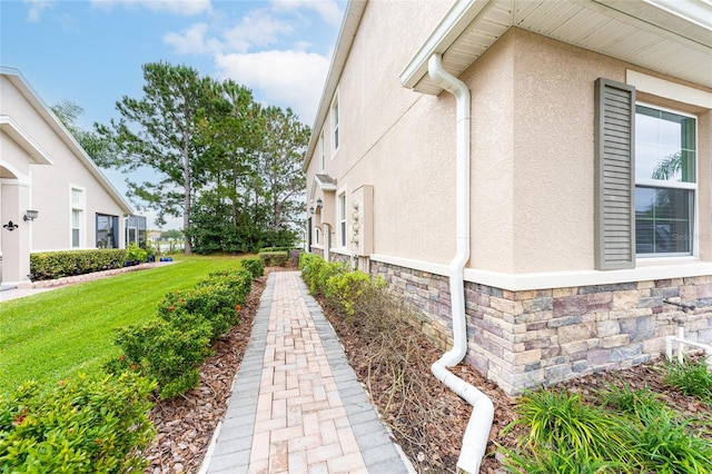 3844 Silverlake Way, Wesley Chapel, FL 33544 - view of home's exterior featuring stone siding, stucco siding, and a yard