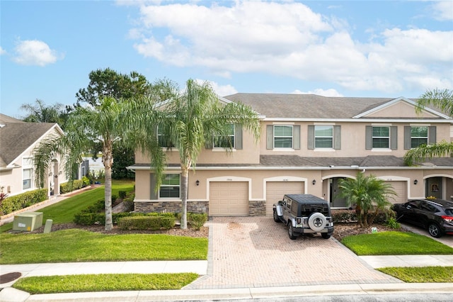 3844 Silverlake Way, Wesley Chapel, FL 33544 - multi unit property with driveway, an attached garage, stucco siding, and stone siding