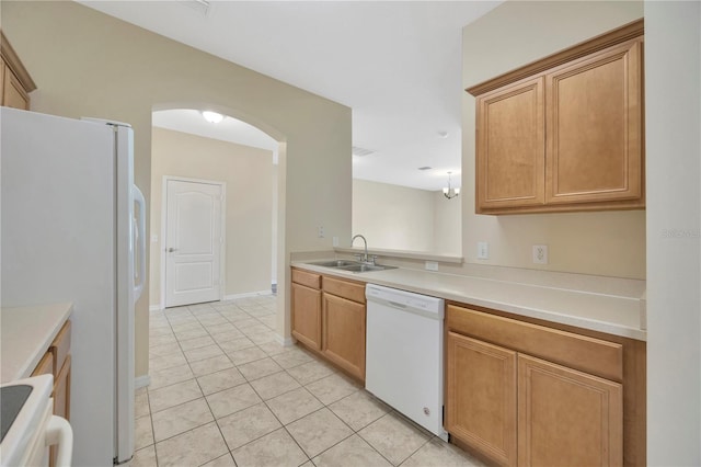 kitchen with light tile patterned floors, baseboards, a sink, light countertops, and white appliances