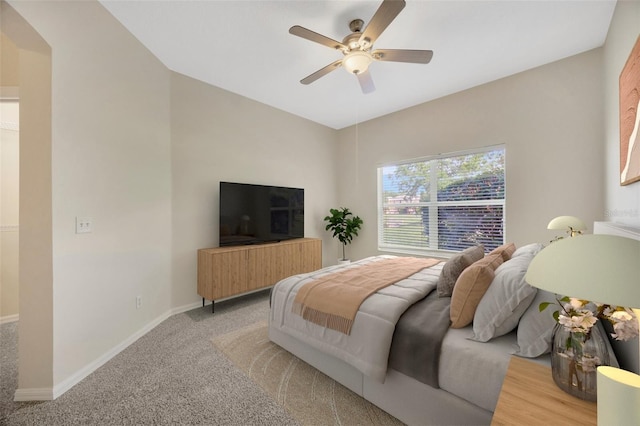 bedroom with light carpet, ceiling fan, and baseboards
