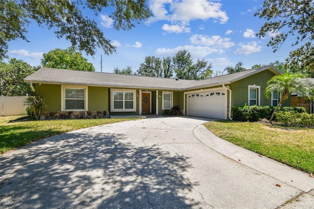ranch-style house featuring a front lawn, concrete driveway, an attached garage, stone siding, and stucco siding