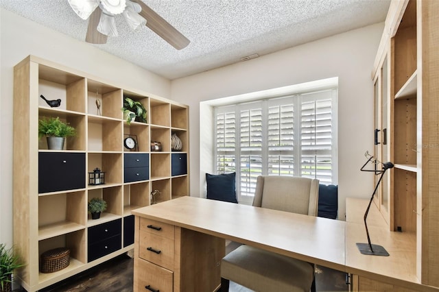 office area with a textured ceiling, dark wood-style floors, and ceiling fan