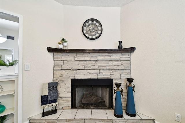 interior details featuring visible vents and a stone fireplace