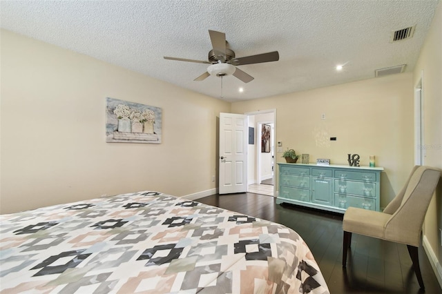 bedroom with visible vents, recessed lighting, a textured ceiling, and dark wood-style floors