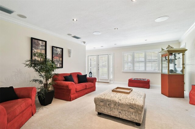living area featuring carpet flooring, crown molding, recessed lighting, baseboards, and visible vents