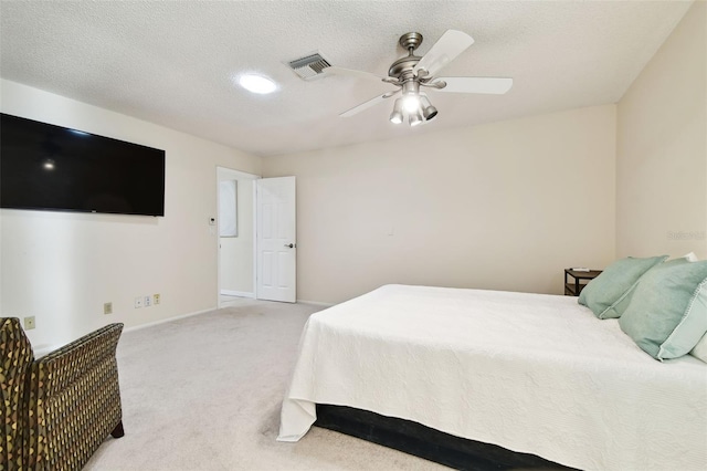 bedroom featuring ceiling fan, a textured ceiling, light colored carpet, visible vents, and baseboards