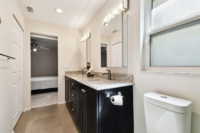 ensuite bathroom with double vanity, a ceiling fan, visible vents, a sink, and ensuite bathroom