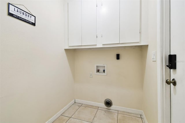 washroom featuring cabinet space, light tile patterned flooring, baseboards, and washer hookup