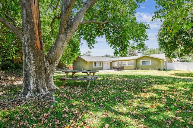 exterior space with a patio, fence, and a front yard