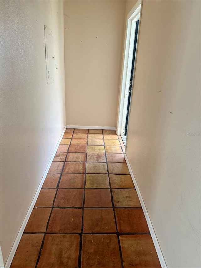 1550 11th St NE Unit G8, Winter Haven, FL 33881 - hallway featuring electric panel, tile patterned floors, and baseboards