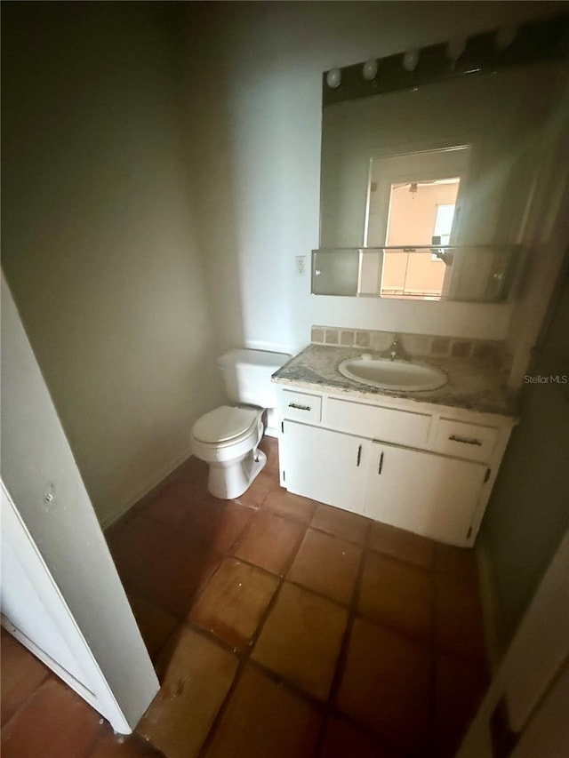 1550 11th St NE Unit G8, Winter Haven, FL 33881 - bathroom featuring toilet, tile patterned floors, and vanity