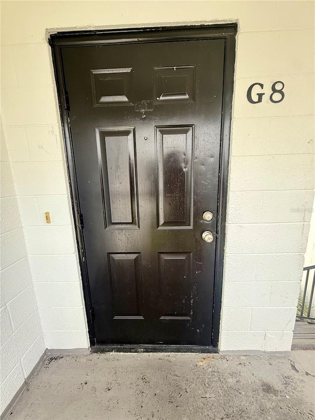 1550 11th St NE Unit G8, Winter Haven, FL 33881 - property entrance featuring concrete block siding