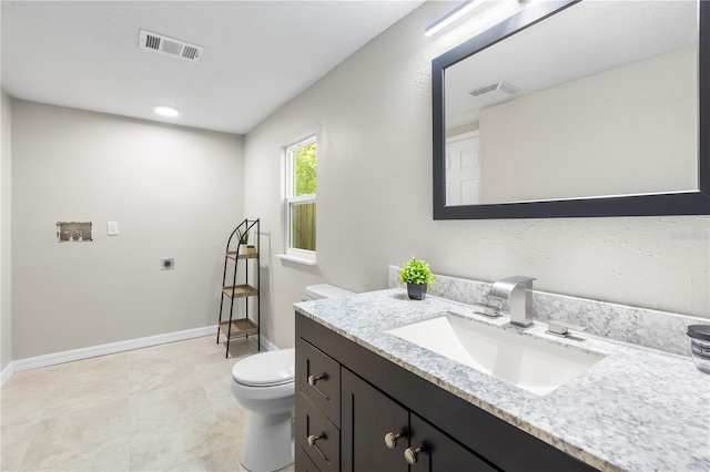 bathroom with vanity, visible vents, baseboards, and toilet
