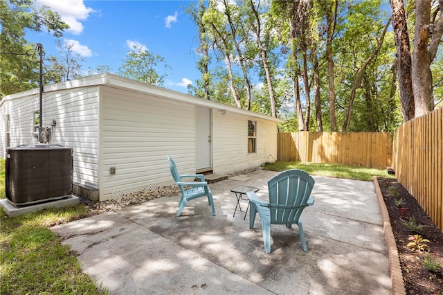 view of patio / terrace featuring central air condition unit and a fenced backyard