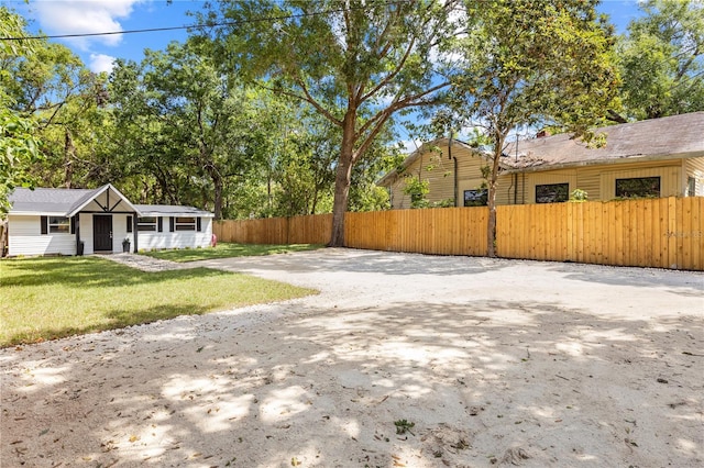 view of yard with driveway and a fenced front yard